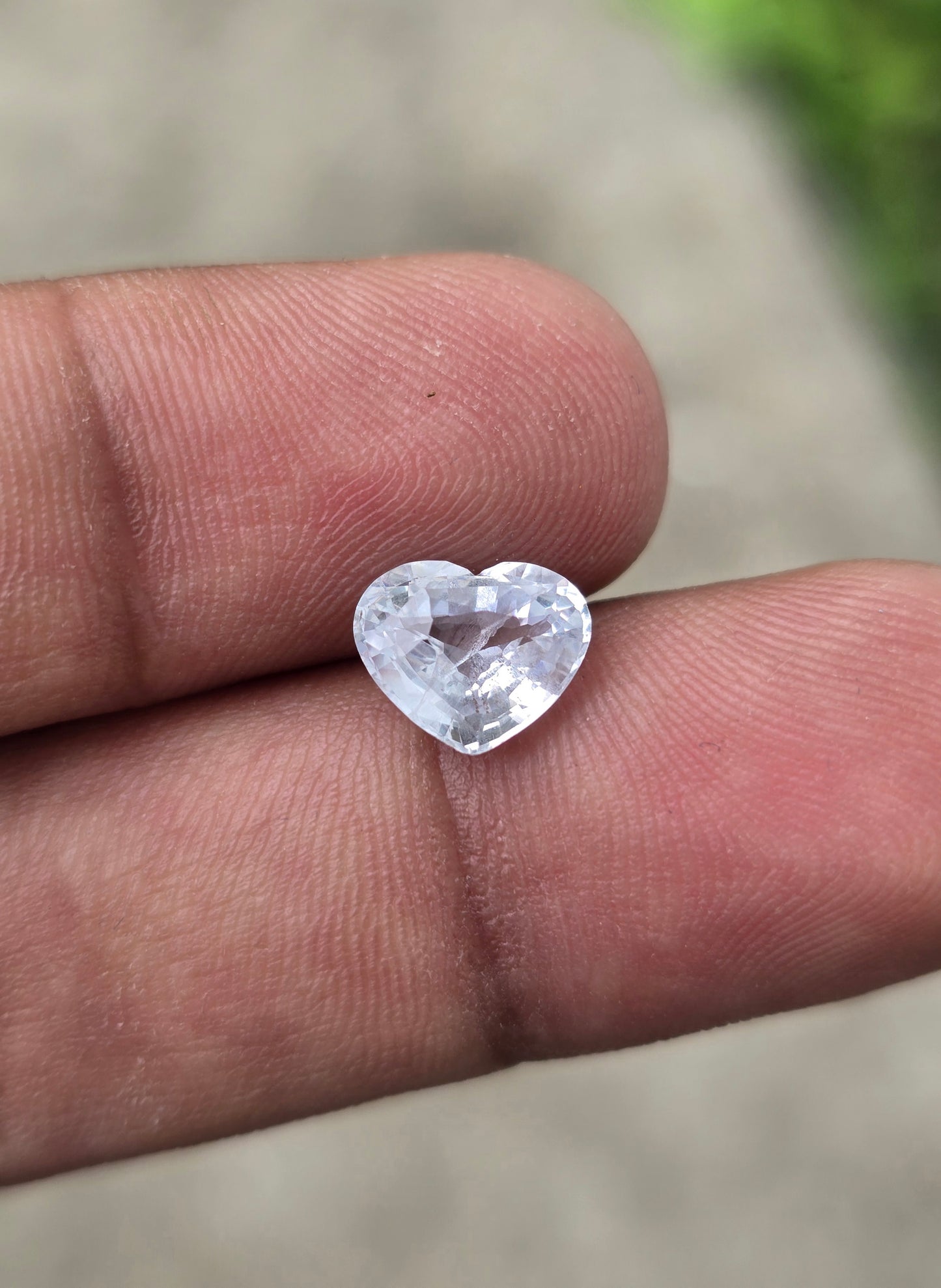 Natural white sapphire heart cut showing brilliant facets and VS clarity