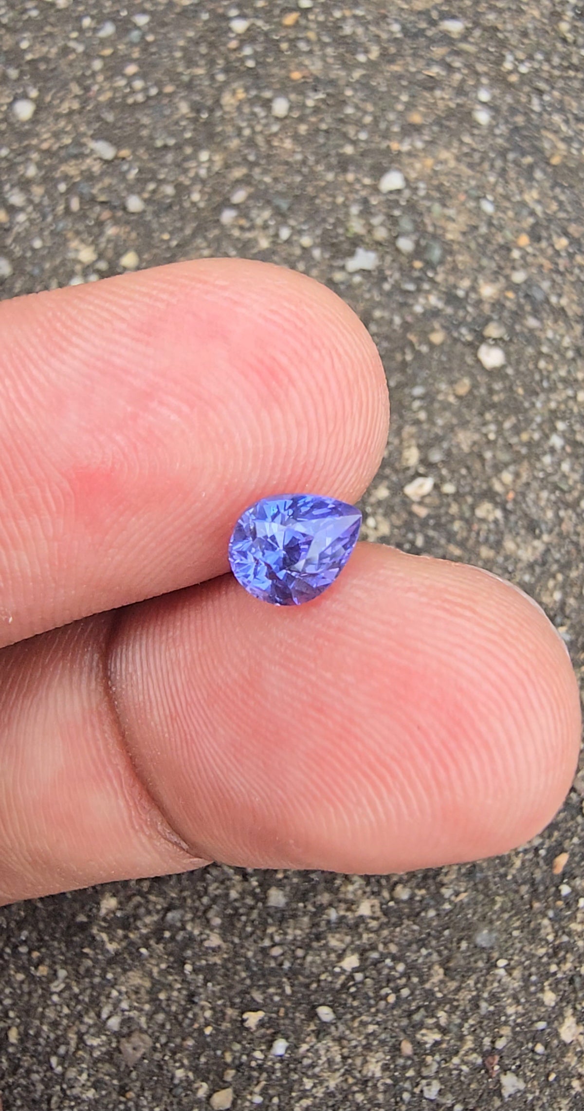 Angled view of lavender violet pear-cut sapphire with its point facing right